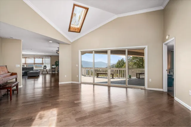 a view of a livingroom with furniture wooden floor and windows
