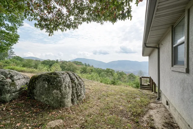 a kitchen with granite countertop stainless steel appliances a sink counter space and a window