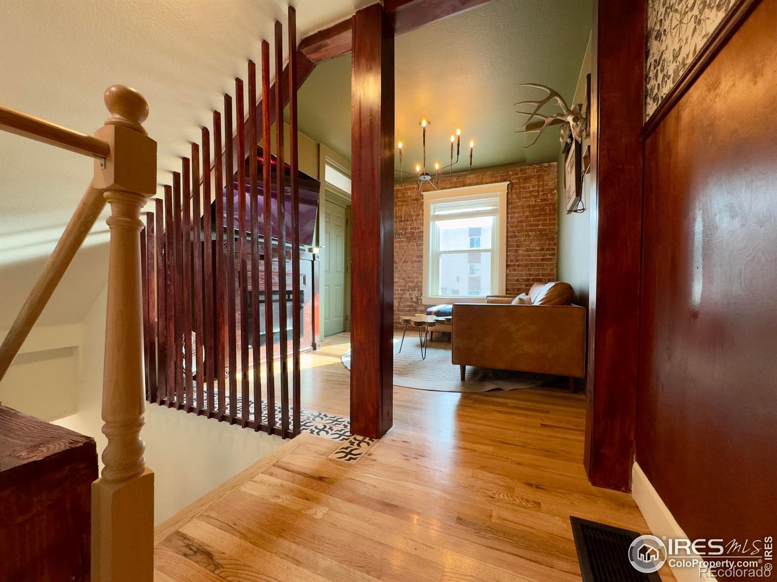 610 Logan Street, Unit 7 Denver, CO 80203 - Photo 12 of 19 a bedroom with a bed and wooden floor
