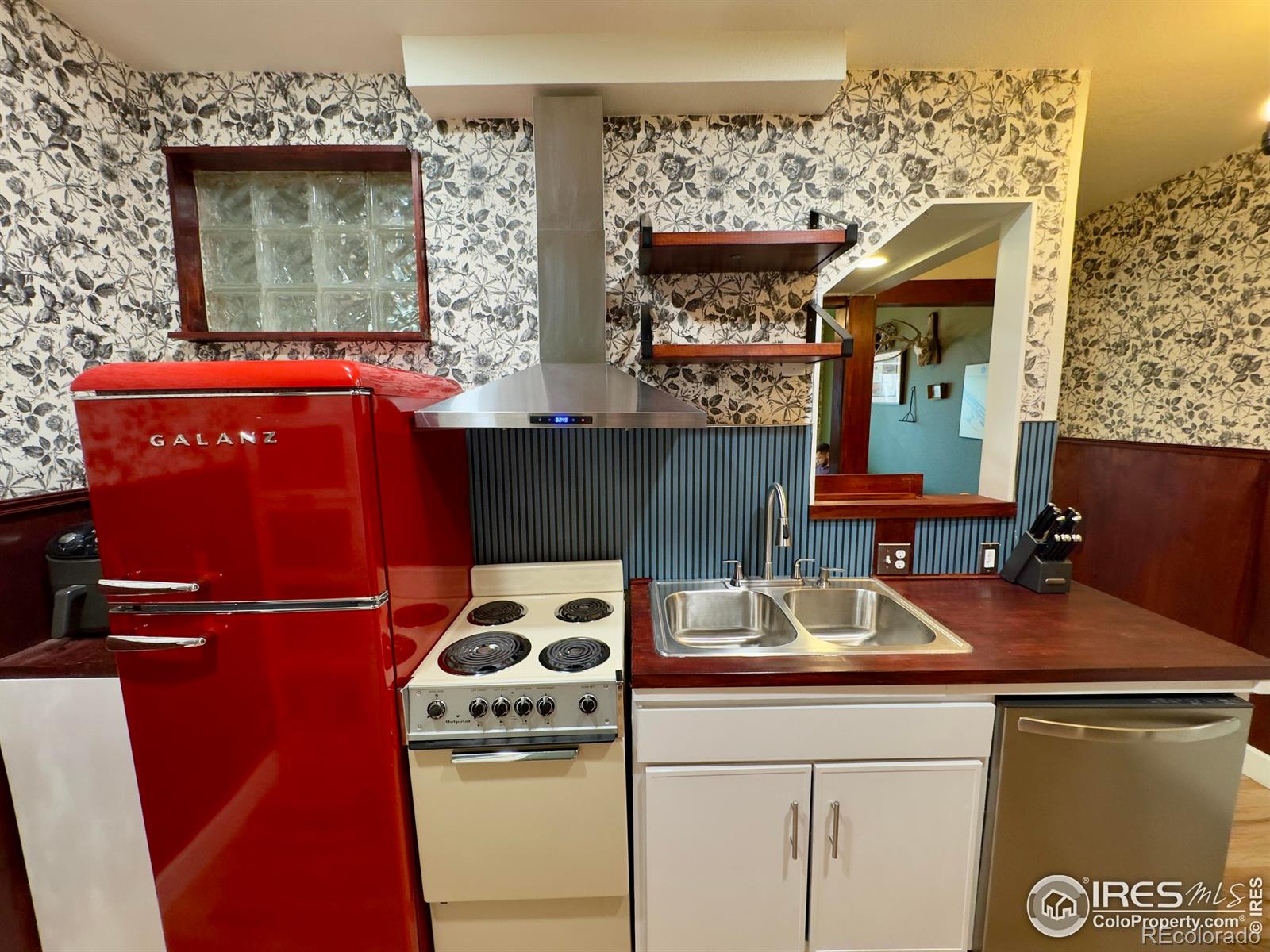 610 Logan Street, Unit 7 Denver, CO 80203 - Photo 7 of 19 a kitchen with a sink a refrigerator and cabinets