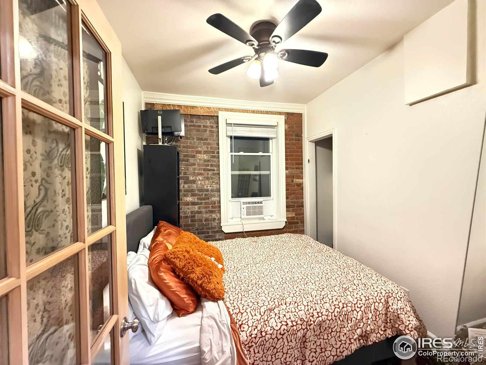 610 Logan Street, Unit 7 Denver, CO 80203 - Photo 9 of 19 a bedroom with a large bed and a large window