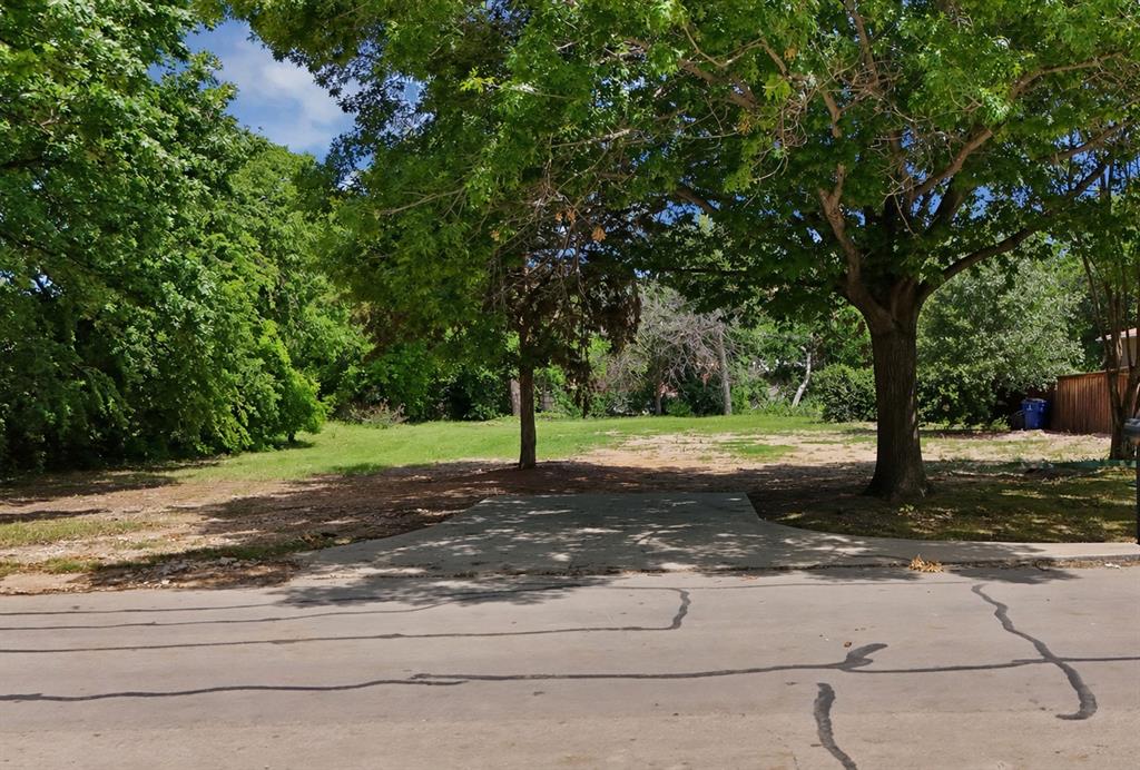6868 Pecan Street Frisco, TX 75034 - Photo 2 of 8 Paved entryway with mature trees and a substantial grassy area