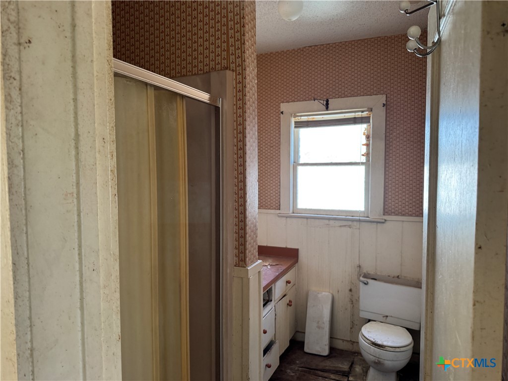 803 North 13th Street Temple, TX 76501 - Photo 11 of 20 a bathroom with a toilet a sink and a window