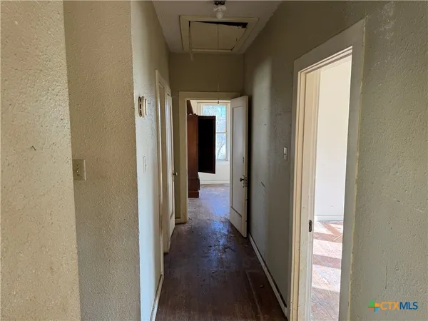 a view of a hallway with a wooden floor