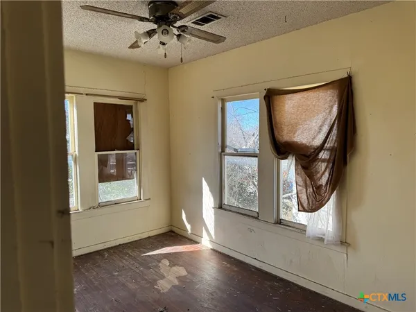 an entryway with wooden floor mirror