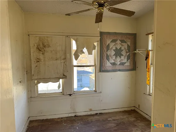 view of a small space with wooden floor and a window
