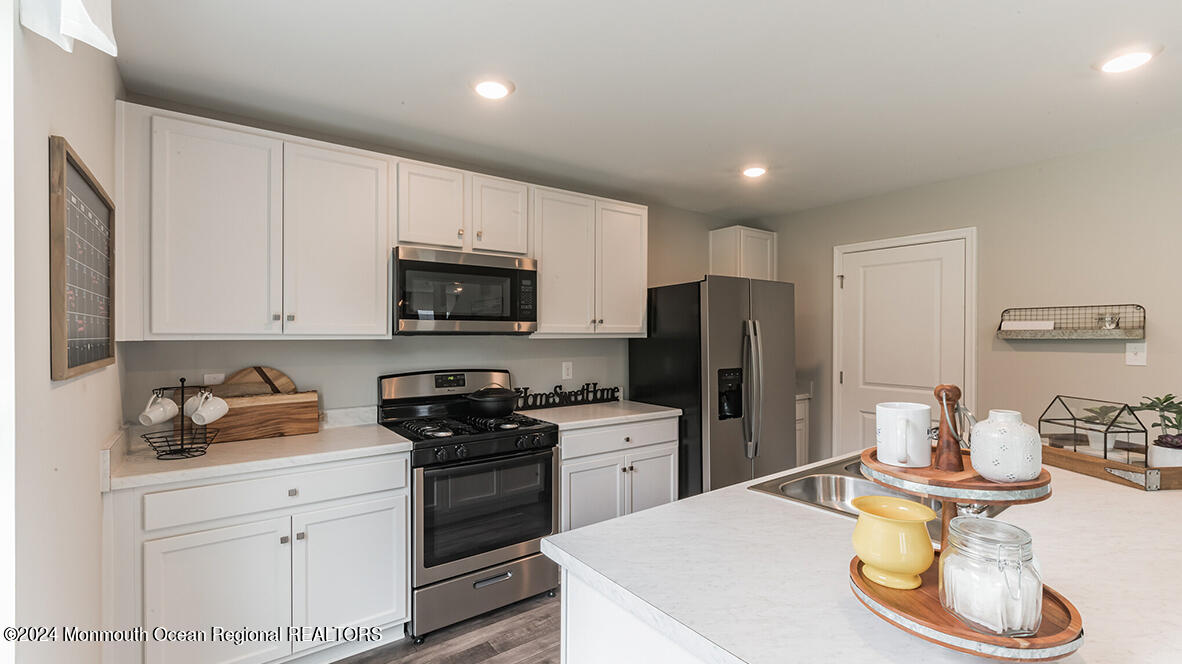 124 West 4th Street Howell, NJ 07731 - Photo 11 of 25 a kitchen with a sink a stove and refrigerator