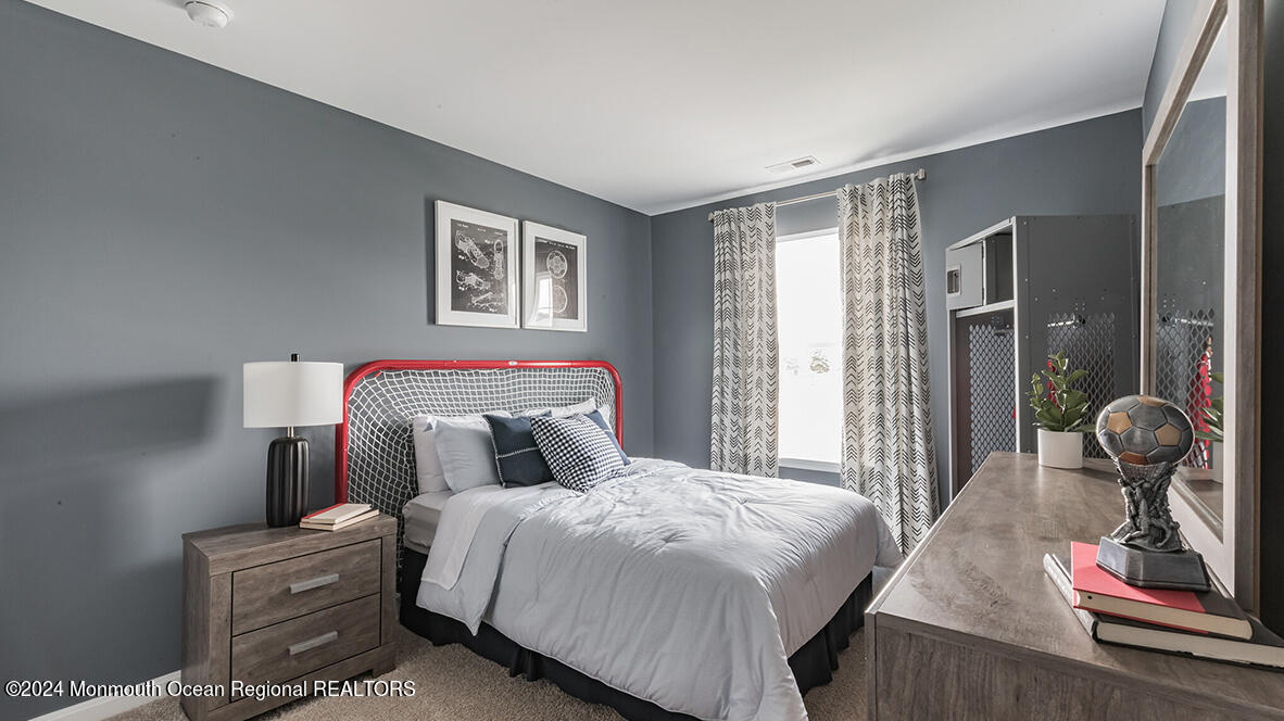 124 West 4th Street Howell, NJ 07731 - Photo 17 of 25 a bedroom with a bed and dresser with mirror