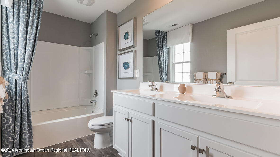 124 West 4th Street Howell, NJ 07731 - Photo 18 of 25 a bathroom with a granite countertop sink toilet mirror and bathtub