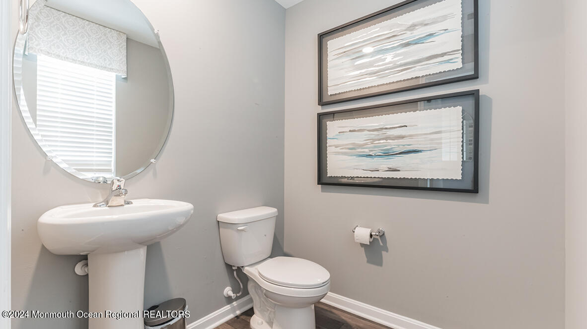 124 West 4th Street Howell, NJ 07731 - Photo 4 of 25 a bathroom with a toilet sink and mirror