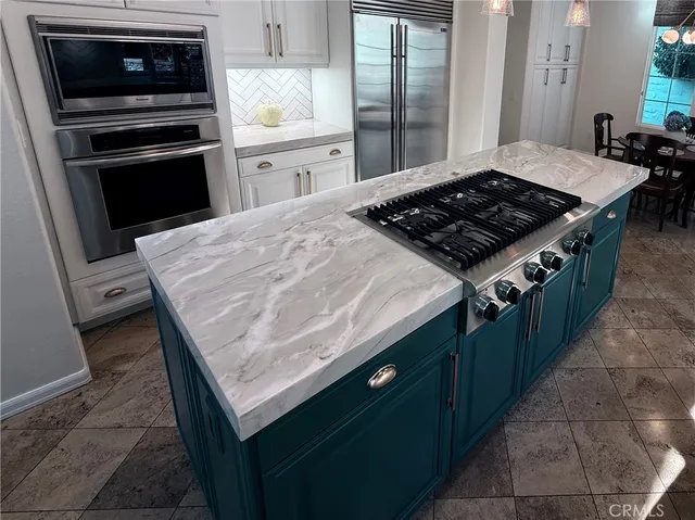 a view of a dining room and livingroom with furniture wooden floor and a rug