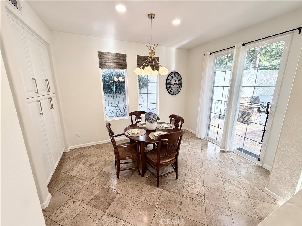 32 Marisol Newport Coast, CA 92657 - Photo 19 of 61 a view of a dining room and livingroom with furniture wooden floor and a rug