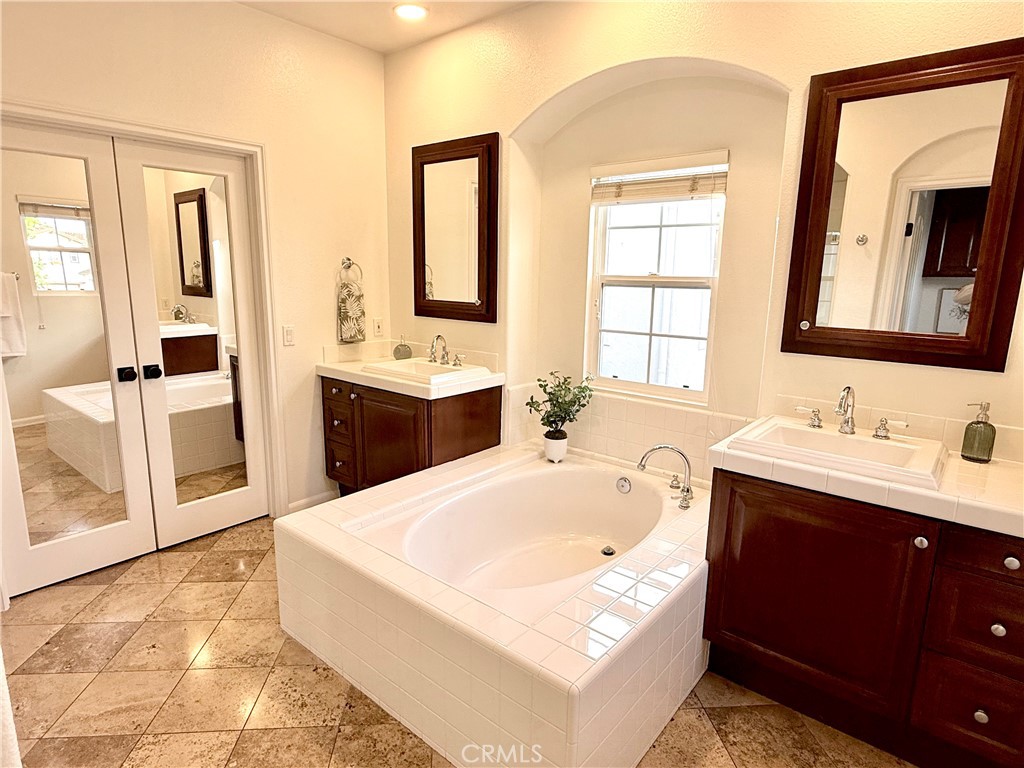 32 Marisol Newport Coast, CA 92657 - Photo 33 of 61 a bathroom with a tub sink and mirror