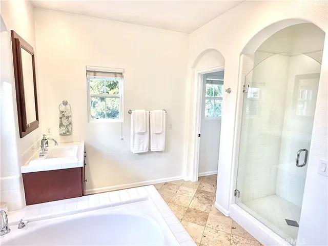 a spacious bedroom with a bed and a couch