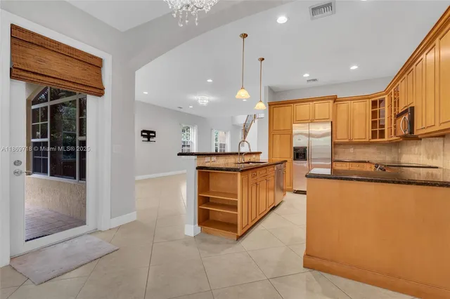 a kitchen with stainless steel appliances granite countertop a stove and a refrigerator