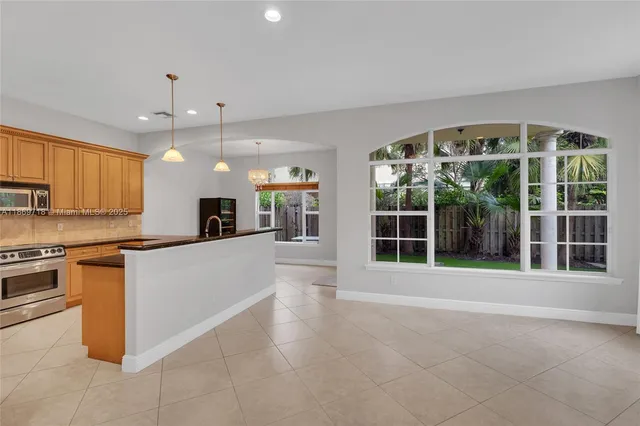 a view of a kitchen with granite countertop a large window