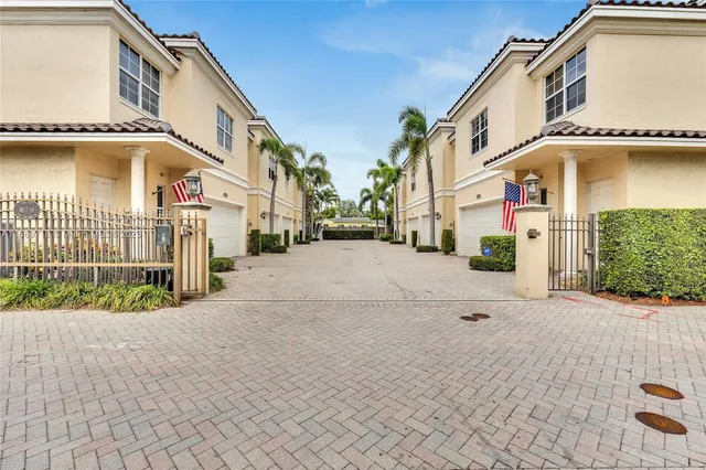 a view of a white house with a yard and garage