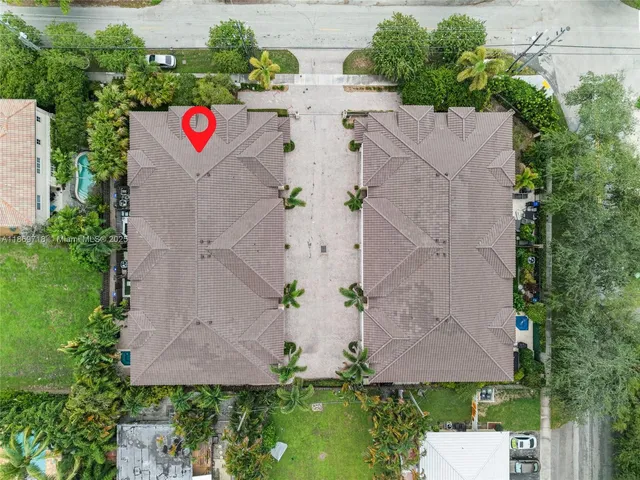 an aerial view of residential houses with outdoor space and street view