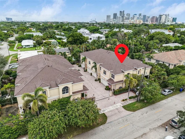 an aerial view of multiple houses with yard