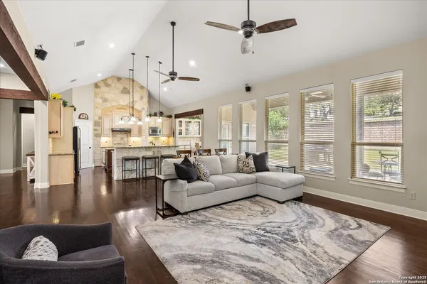 a living room with lots of furniture and a large window