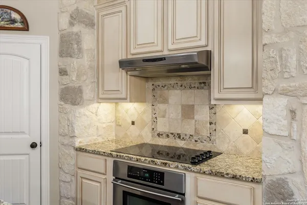a stove top oven sitting inside of a kitchen
