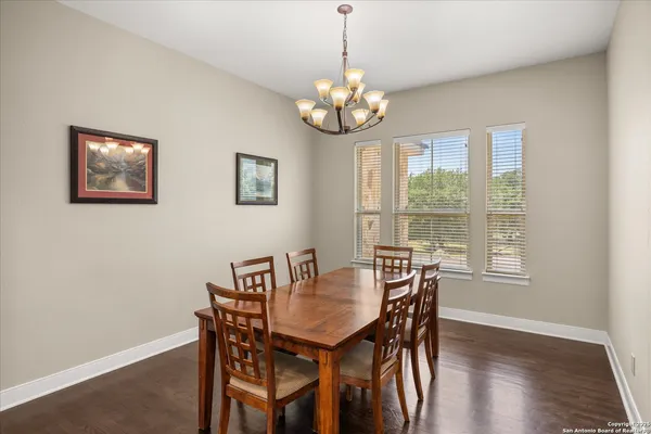 a view of a dining room with furniture wooden floor and chandelier