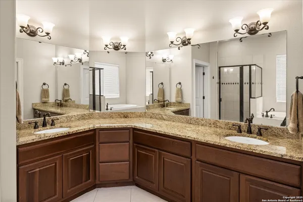 a bathroom with a sink double vanity and a mirror