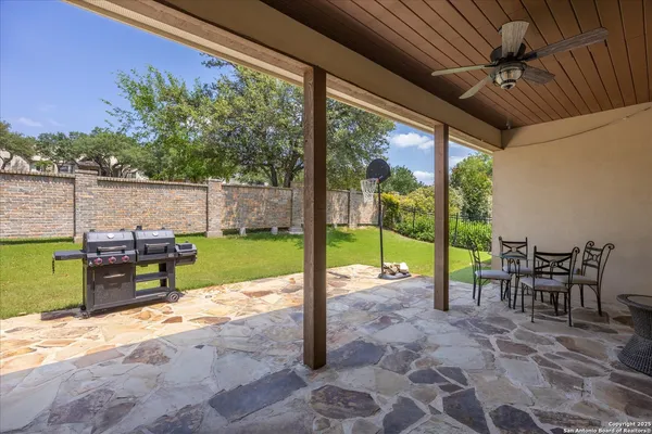 a view of a patio with a table chairs and a backyard