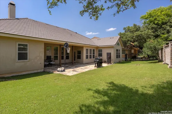 a view of a house with swimming pool and a yard
