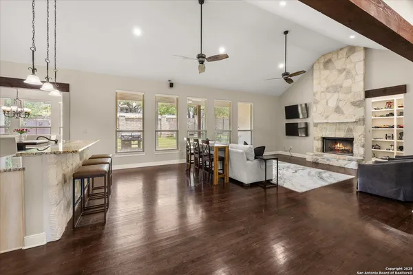 a living room with fireplace furniture and a wooden floor