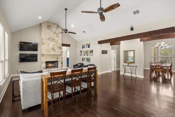 a view of dining room and livingroom with furniture wooden floor a chandelier