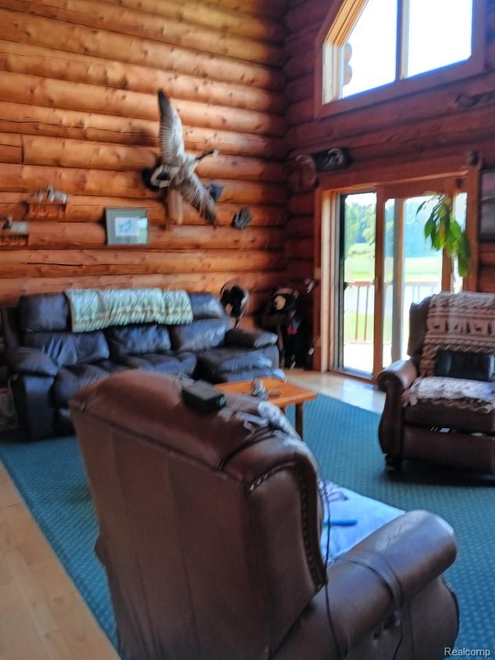 10374 Wilson Road Otisville, MI 48463 - Photo 51 of 99 Living area featuring log walls
