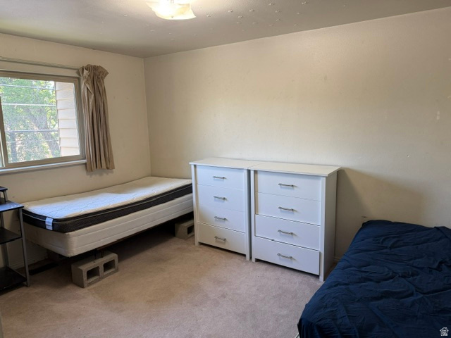261 North 400 East, Unit 301 Provo, UT 84606 - Photo 6 of 8 Light-colored carpeting provides a neutral base in this room, complemented by white walls and a window with a light-colored curtain
