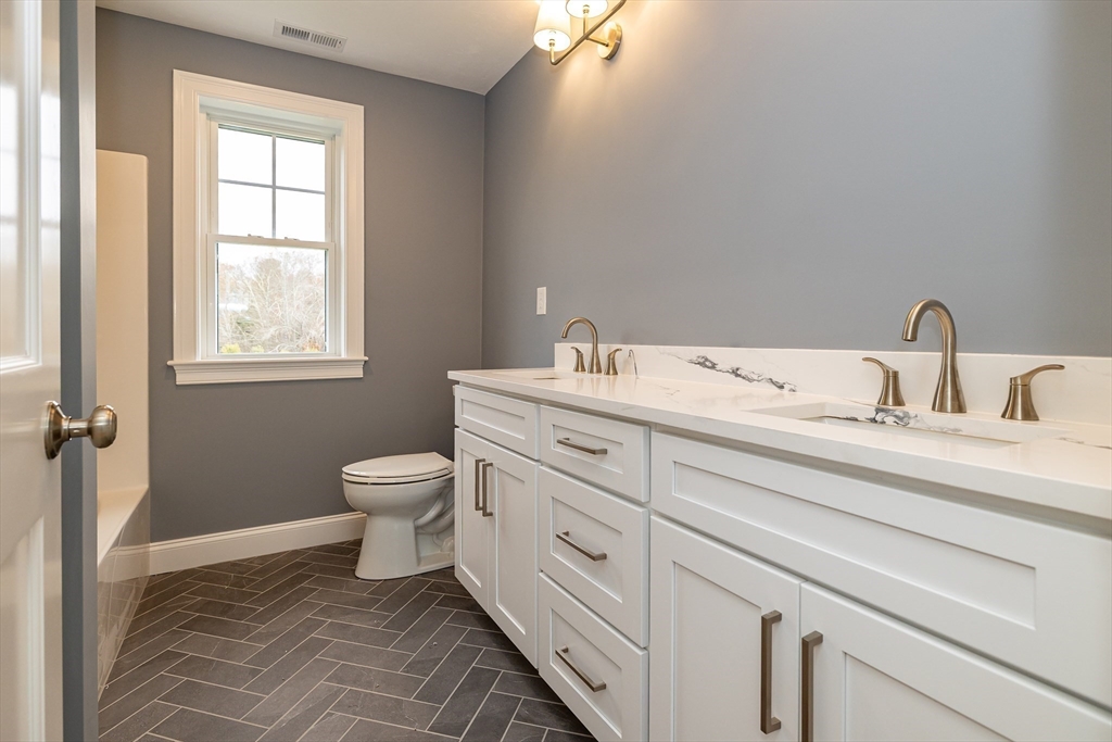 254 Concord Road, Unit LOT 2A Westford, MA 01886 - Photo 19 of 29 a bathroom with a granite countertop toilet sink and mirror