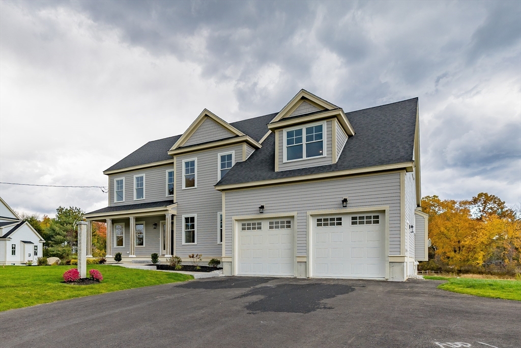254 Concord Road, Unit LOT 2A Westford, MA 01886 - Photo 2 of 29 a front view of a house with a garden and yard