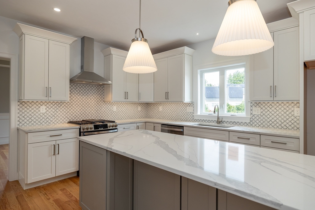 254 Concord Road, Unit LOT 2A Westford, MA 01886 - Photo 6 of 29 a kitchen with stainless steel appliances a sink a stove a window and cabinets