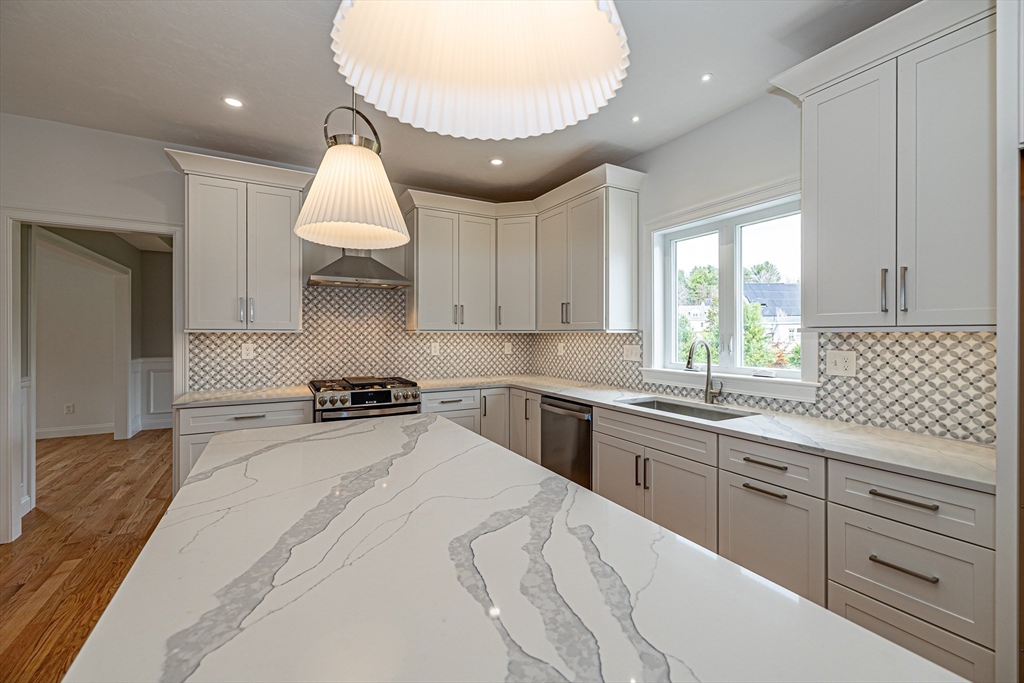 254 Concord Road, Unit LOT 2A Westford, MA 01886 - Photo 9 of 29 a kitchen with granite countertop a sink a stove and cabinets