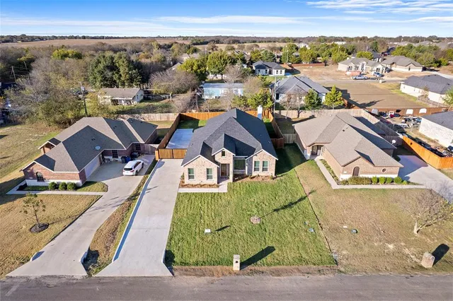an aerial view of residential house with yard