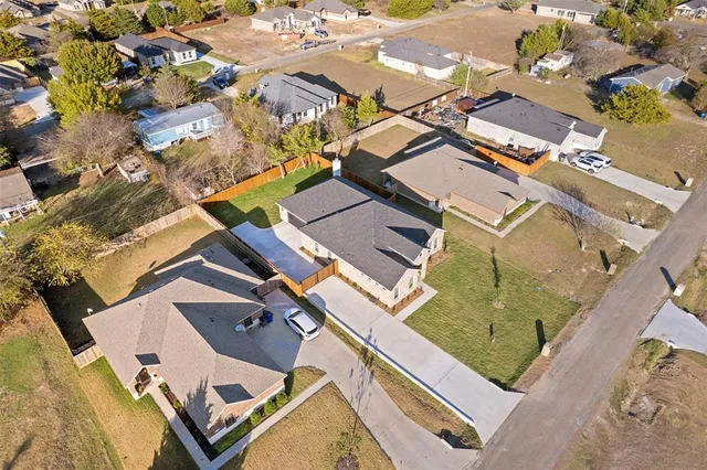 an aerial view of a house with a yard