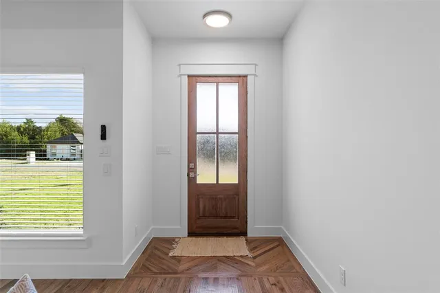 a living room with furniture fireplace and wooden floor