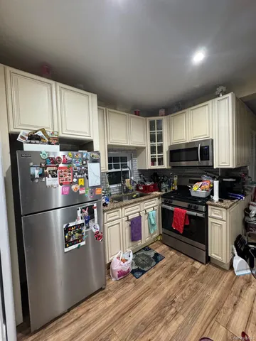 a kitchen with granite countertop stainless steel appliances and wooden cabinets