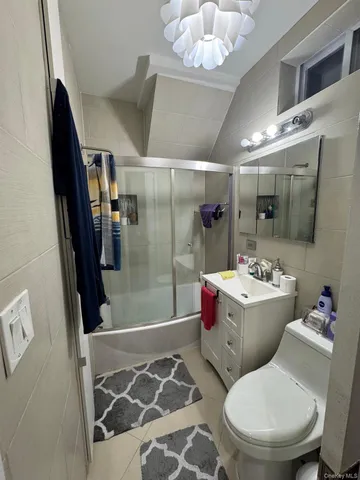 a bathroom with a sink mirror vanity and toilet