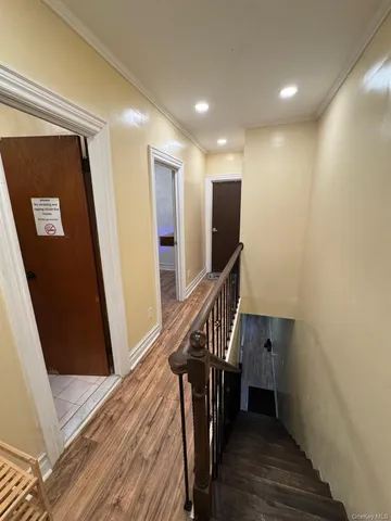 a view of entryway with wooden floor and stairs