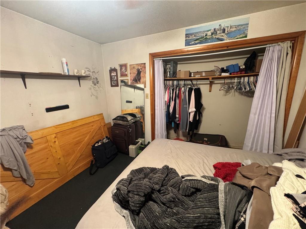 215 Maple Street Kittanning, PA 16201 - Photo 24 of 39 a bedroom with a bed and a walk in closet