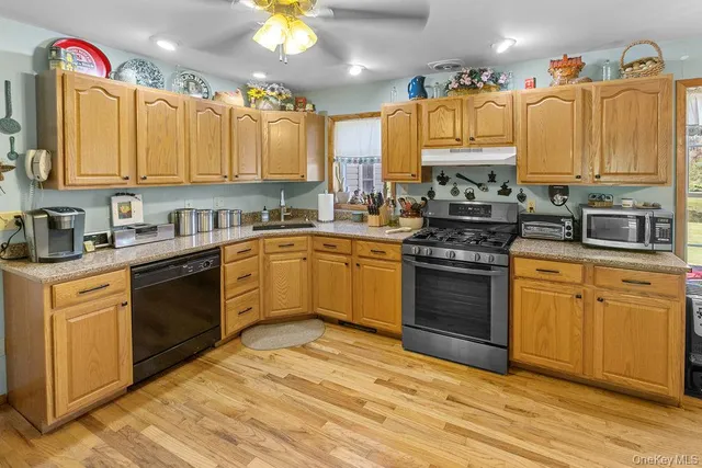 a kitchen with a sink stove and cabinets
