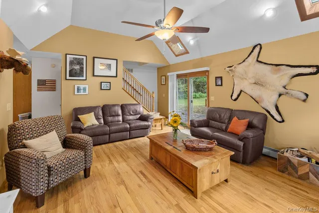 a living room with furniture and a ceiling fan