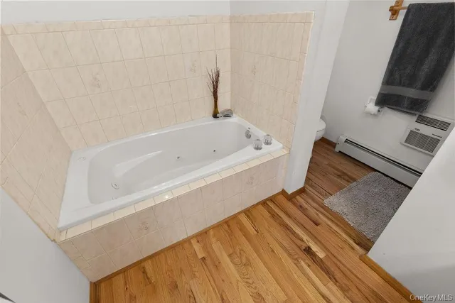 a bathroom with a tub sink and a mirror