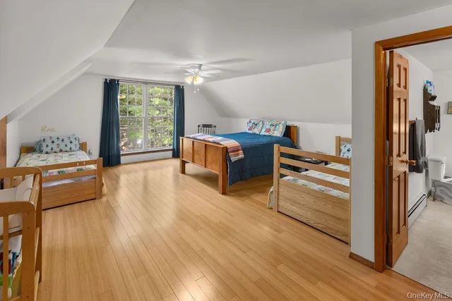 a bedroom with furniture and a wooden floor