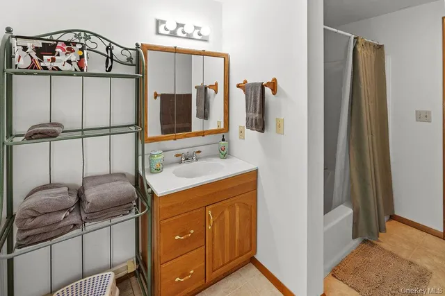 a bathroom with a sink vanity and a mirror