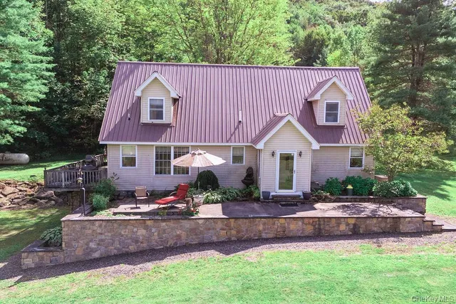 a view of a house with a yard and sitting area